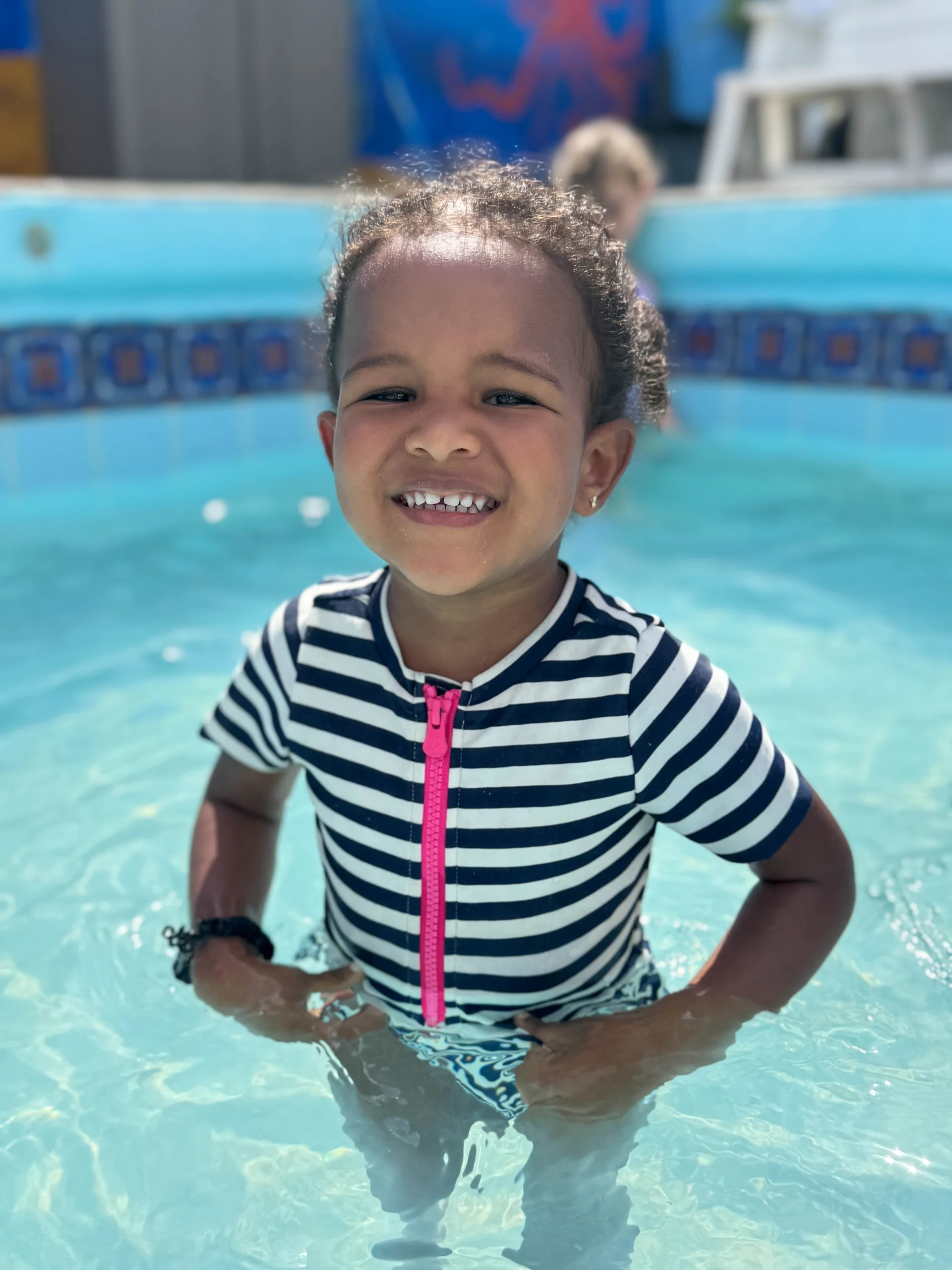 little girl proud to be in the swimming pool for her swim camp near mt vernon